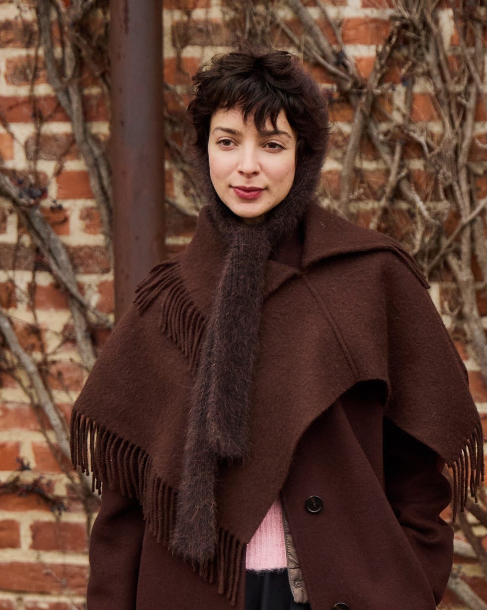 a figure wearing a layered brown outfit suitable for cold weather