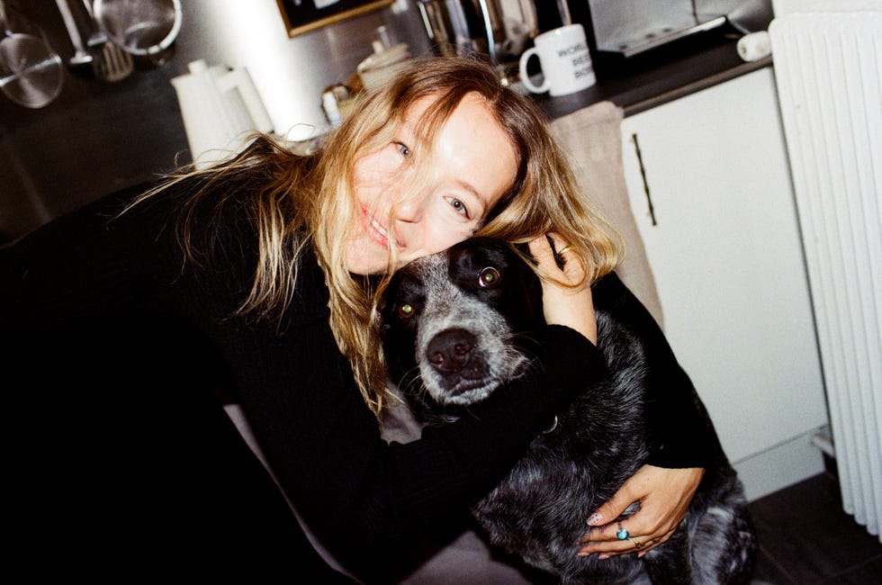 woman embracing a dog indoors